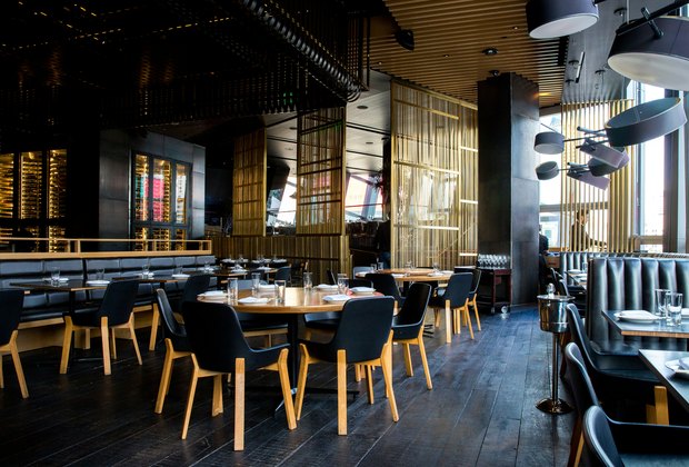 Warm restaurant dining room prepared for dinner service.