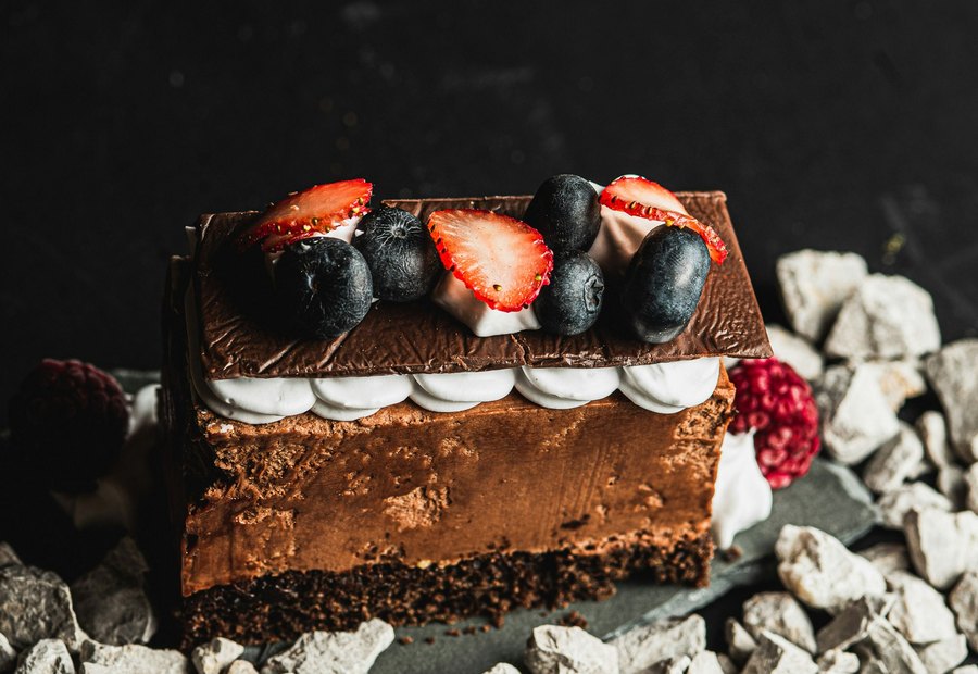 Chocolate dessert with cream on a plate.