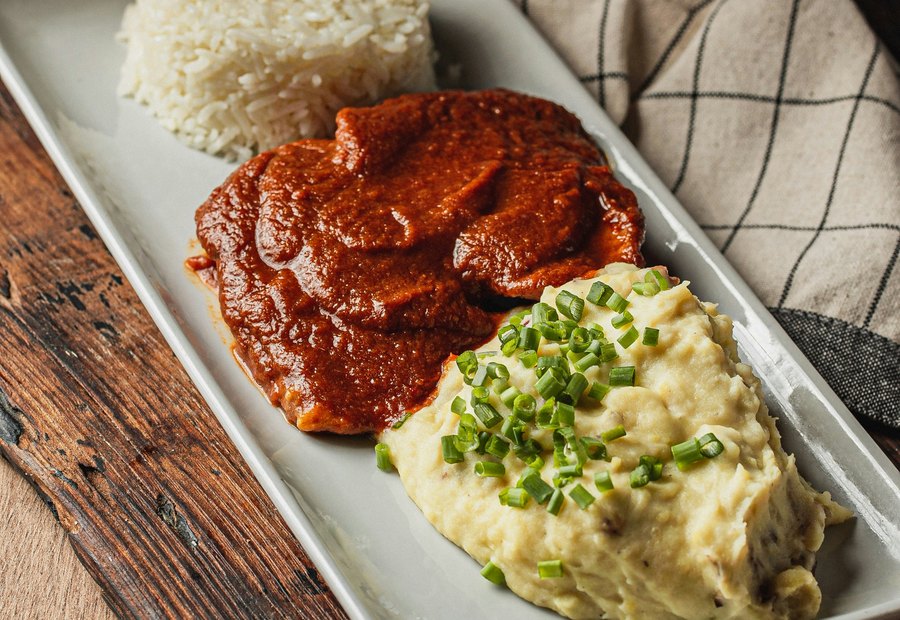 A Kenyan-style plate with stew and sides.