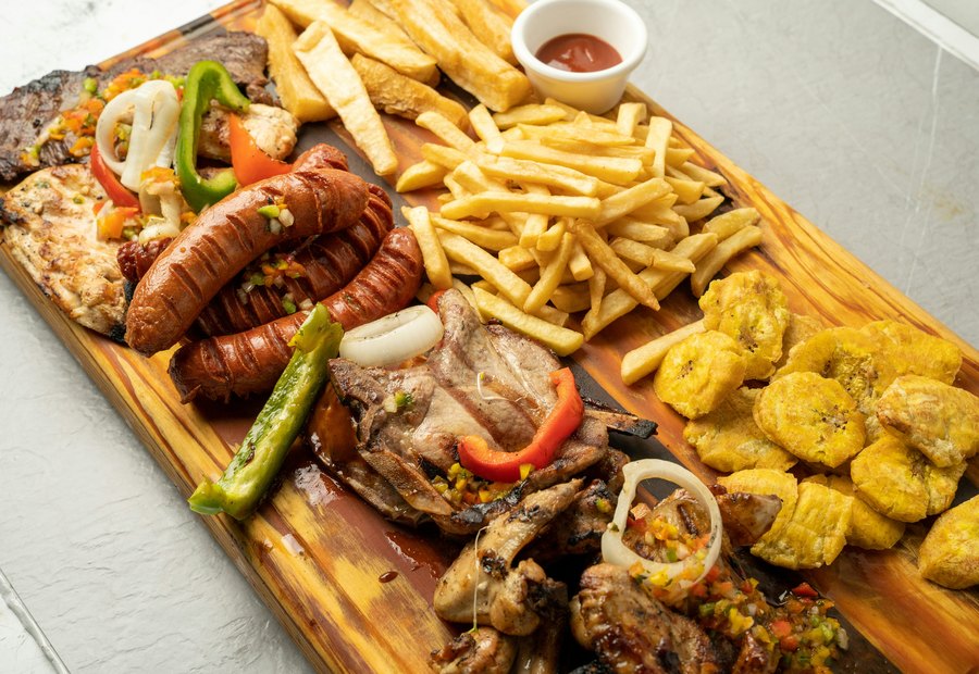 Braised meat served with vegetables and sauce.