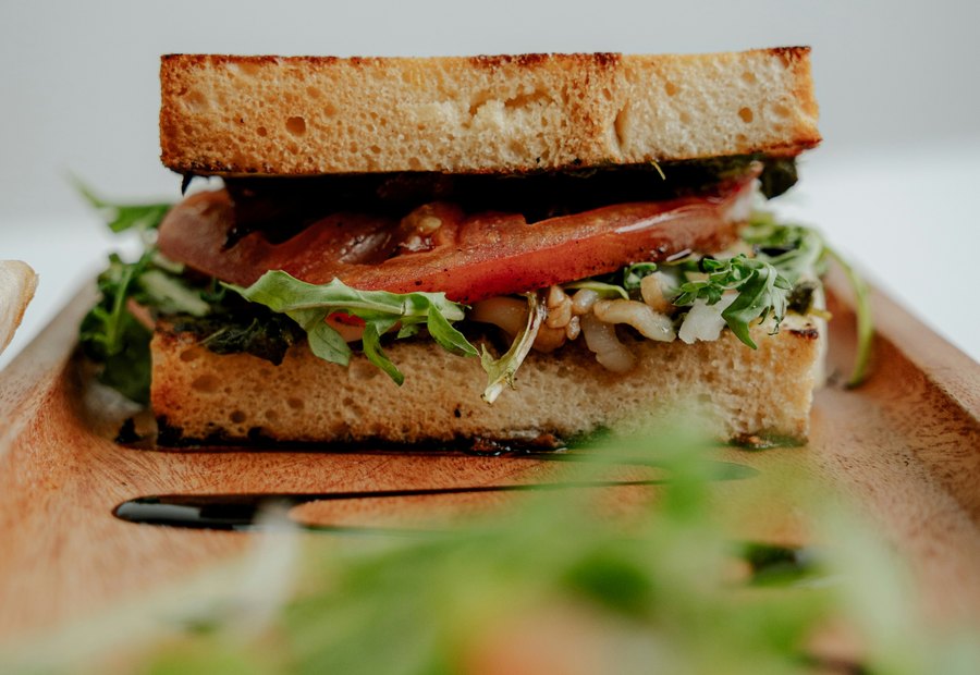 A long sandwich filled with vegetables and meat.